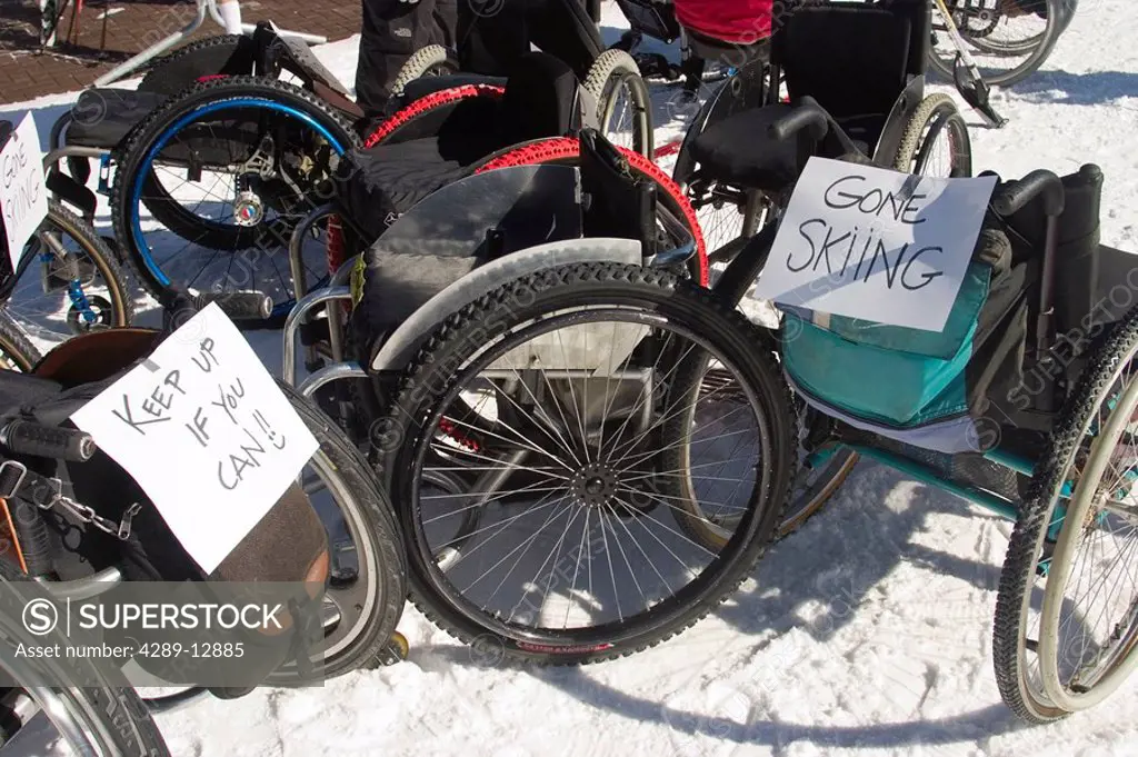 Wheel chairs & prosthetic sit vacant with *gone skiing* sign Telluride Colorado