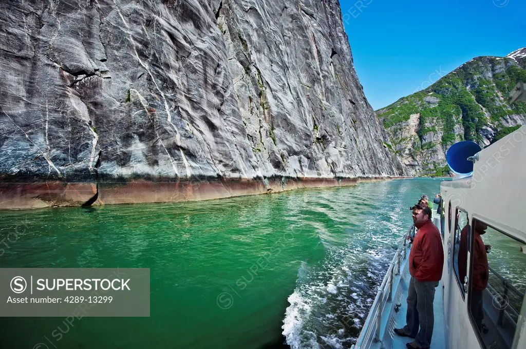 Visitors view steep granite walls of a fjord in Tracy Arm, Tracy Arm_Fords Terror Wilderness in Southeast Alaska, Summer