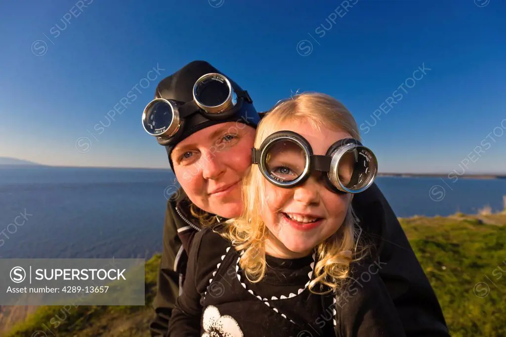 Mother and daughter wearing goggles and riding a vintage Vespa, Pt. Woronzof, Cook Inlet, Anchorage, Southcentral Alaska, Summer