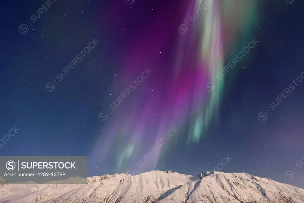 Northern Lights aurora borealis and Big Dipper Ursula Major over the Talkeetna Mountains in Hatcher Pass on a clear cold winter night, Southcentral Al...