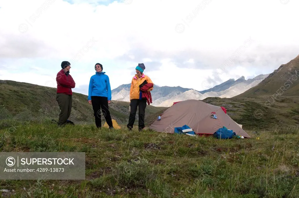Mature female hikers at campsite along the Marsh Fork of the Canning River in the Brooks Range, Arctic National Wildlife Refuge, Alaska, Summer