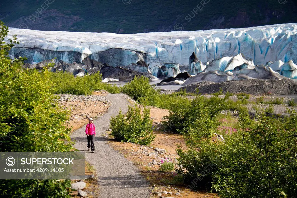 Woman walking a path to the Spencer Glacier, Kenai Mountains, Southcentral Alaska, Summer