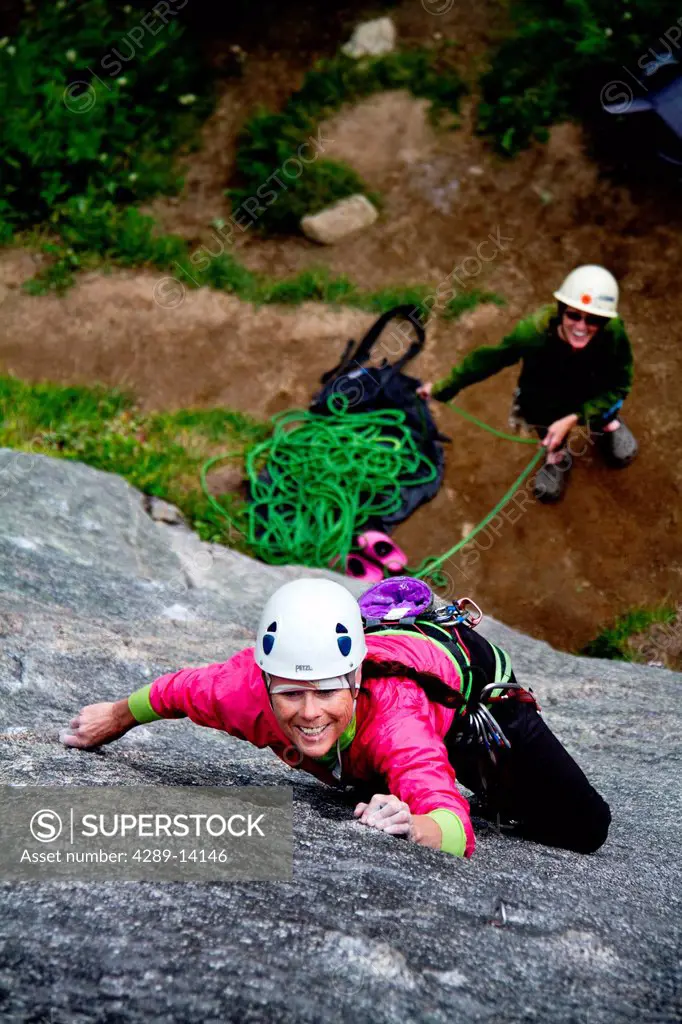 Two women rock climbing on the Monolith, Archangel Road, Talkeetna Mountains, Southcentral Alaska, Summer