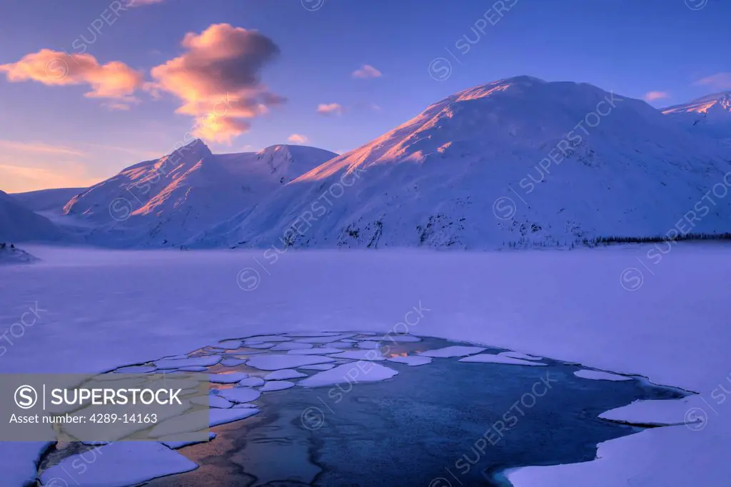Dawn light on the snow capped peaks around frozen Portage Lake, Chugach National Forest, Southcentral Alaska, Winter, HDR