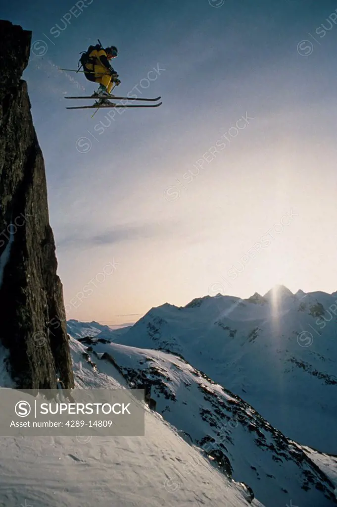 Skier skiing off cliff Chugach Mtns SC Alaska