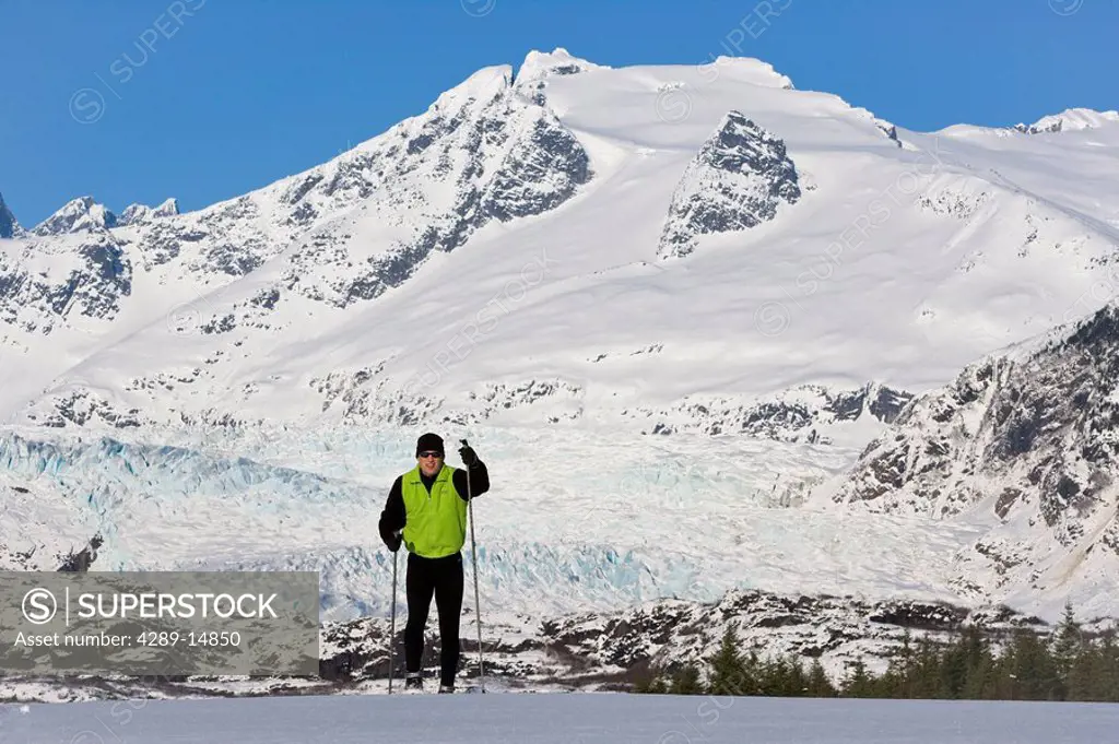 Nordic skier enjoying the wide open and uncrowded skiing in the Juneau area, Mendenhall Glacier and Towers beyond, Alaska.