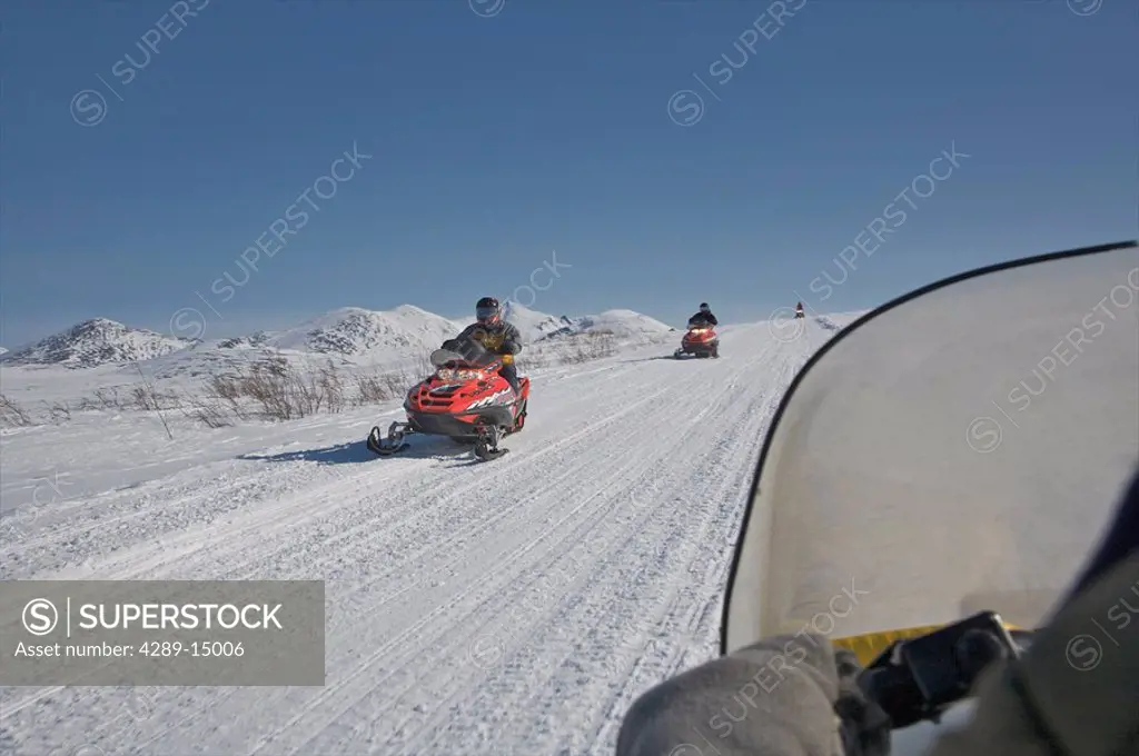 Snowmobiles travelling on Denali Highway in Winter, Alaska