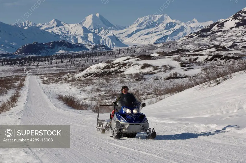 Snowmachiner travelling on Denali Highway in Winter, Alaska