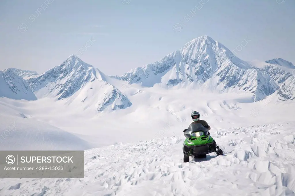 Snowmobiler on Spencer Glacier near the top of Blackstone Glacier, Kenai Mountains, Chugach National Forest, Alaska