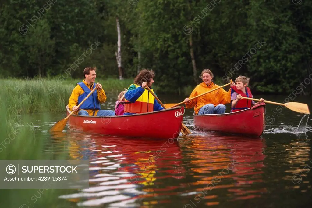 Families canoeing Westchester Lagoon Anchorage SC AK summer scenic