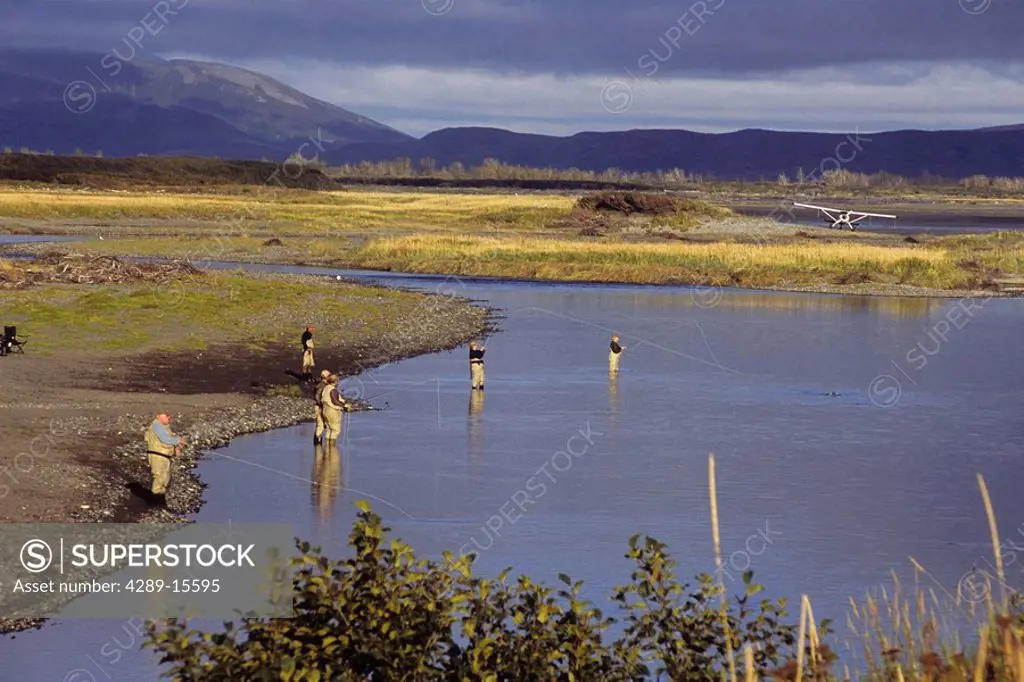 Fishermen flyfish at the Douglas River. Summer at Katmai National Park in Southwest Alaska.
