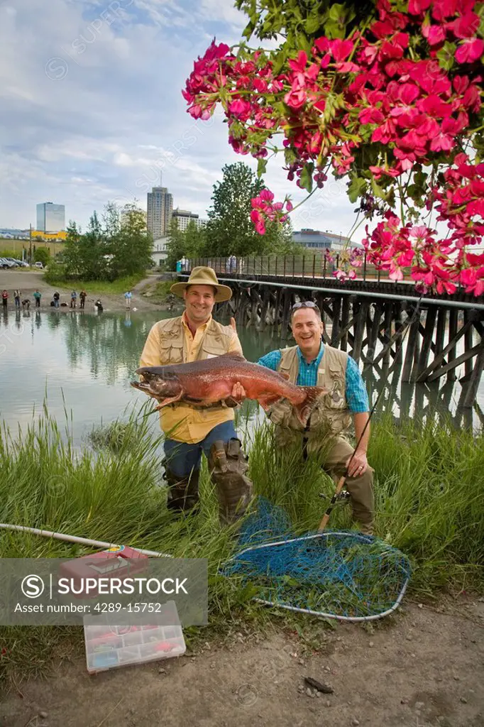 Fishermen poses with King Salmon at Ship Creek in downtown Anchorage, Alaska during Summer