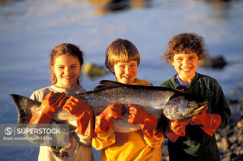 Kids holding King Salmon Juneau Southeast AK summer portrait
