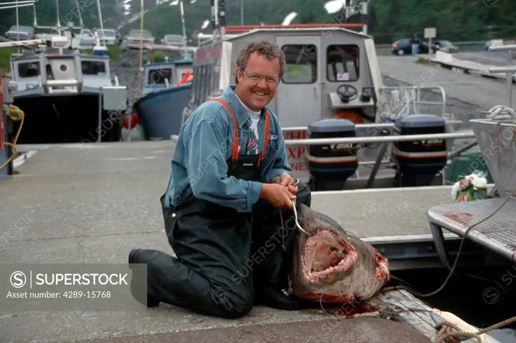 Person Displays Salmon Shark on Whittier Dock AK SC Summer