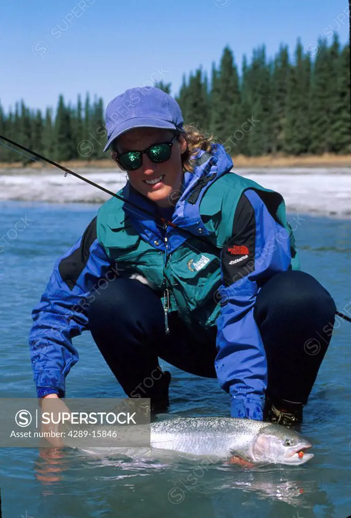 Fisherman holding steelhead Kasilof River SC AK woman summer portrait