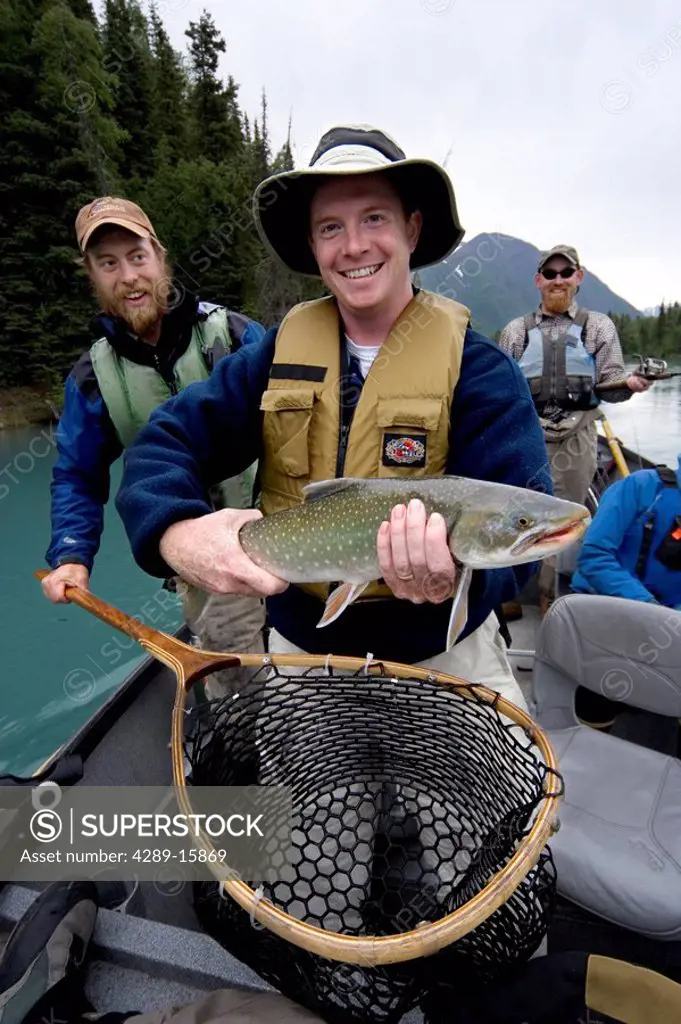 Man holding Dolly Varden caught drift fishing Kenai River Kenai Peninsula Alaska Summer