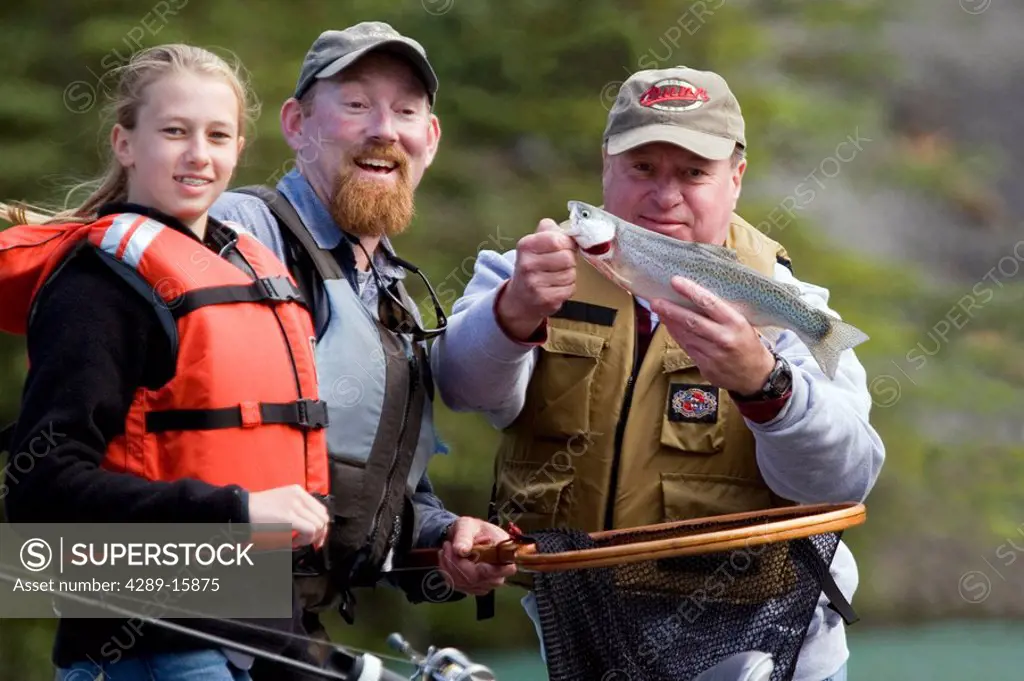 Family & Guide showing off Rainbow Trout caught from drift boat Kenai River Kenai Peninsula Alaska