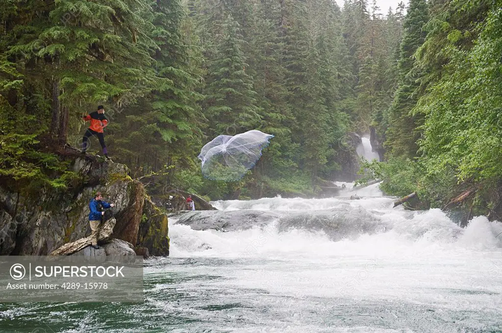 Two fishermen use a cast net to fish for Sockeye salmon in Sweetheart Creek in Southeast Alaska