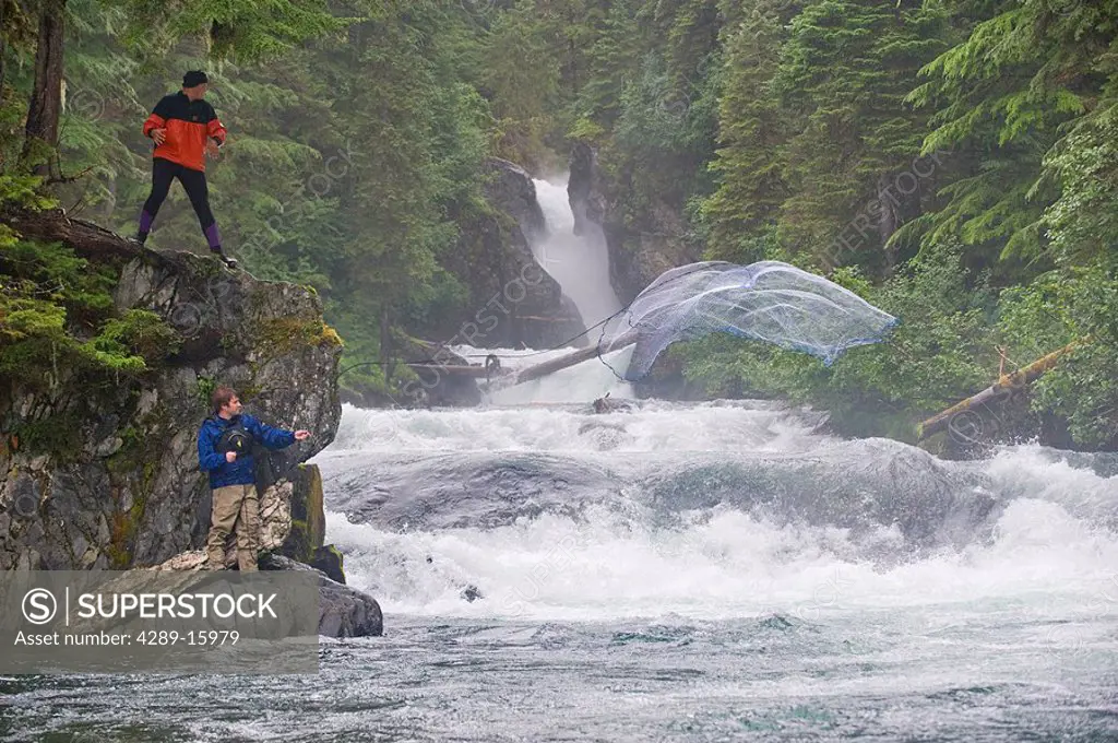 Two fishermen use a cast net to fish for Sockeye salmon in Sweetheart Creek in Southeast Alaska