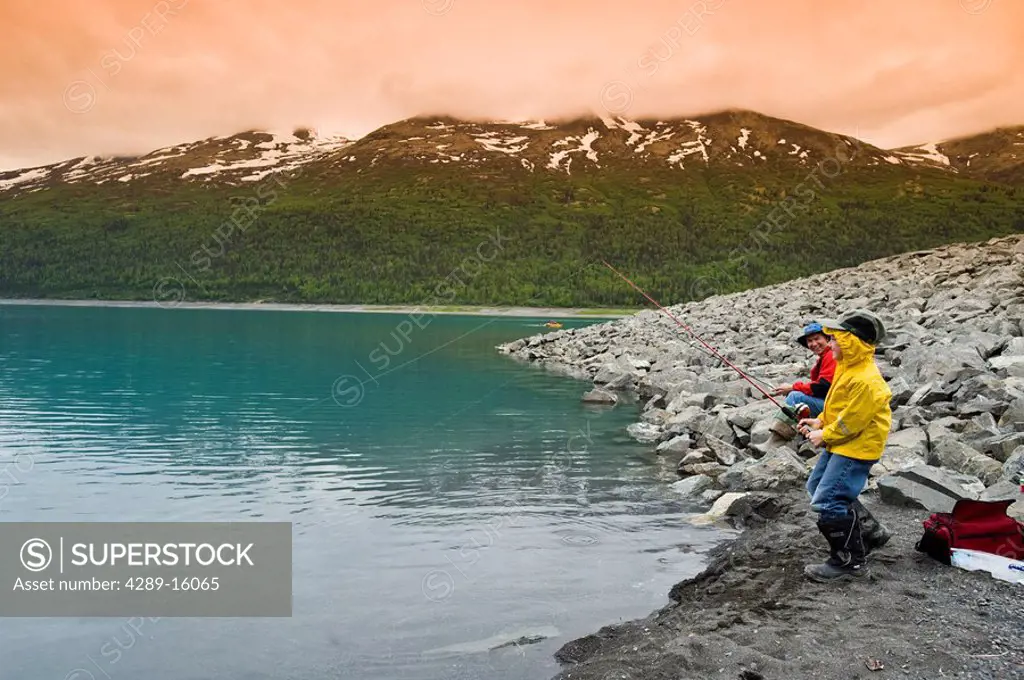 Father and son fishing at Eklutna Lake in Southcentral Alaska during Summer