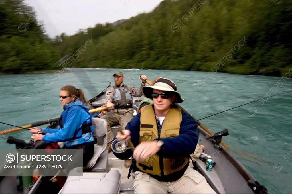Couple spinfishing from drift boat on Kenai River Kenai Peninsula Alaska Summer Blurred Action