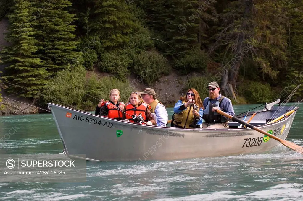 Family spinfishing on Kenai River from drift boat Kenai Peninsula Alaska Summer