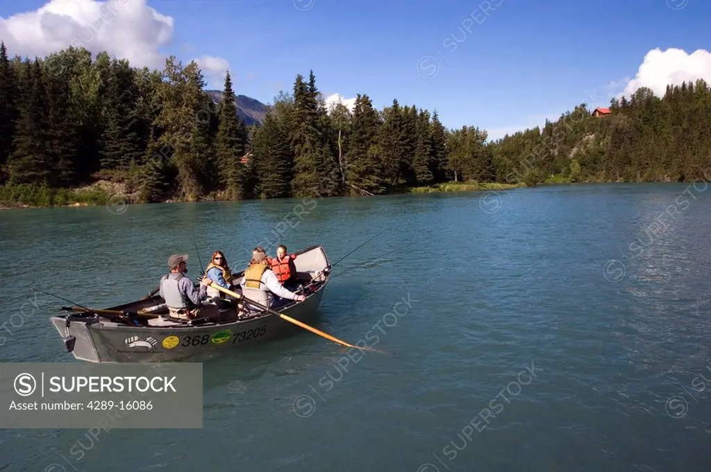 Family spinfishing from drift boat on Kenai River Kenai Peninsula Alaska Summer
