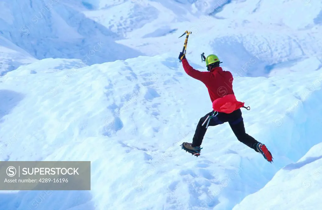 Ice Climber Jumping over Crevasse Matanuska Galcier AK Southcentral Chugach Mts Spring