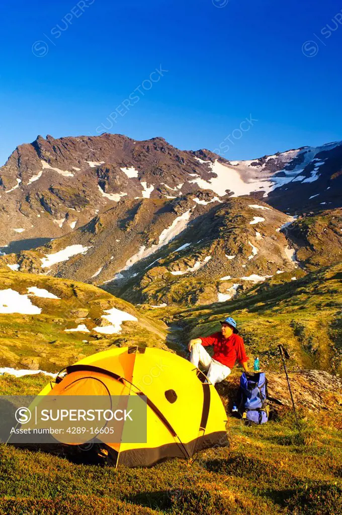 Father and son at his campsite in the Talkeetna Mountains with Bald Mountain Ridge in the background, Southcentral Alaska, Summer