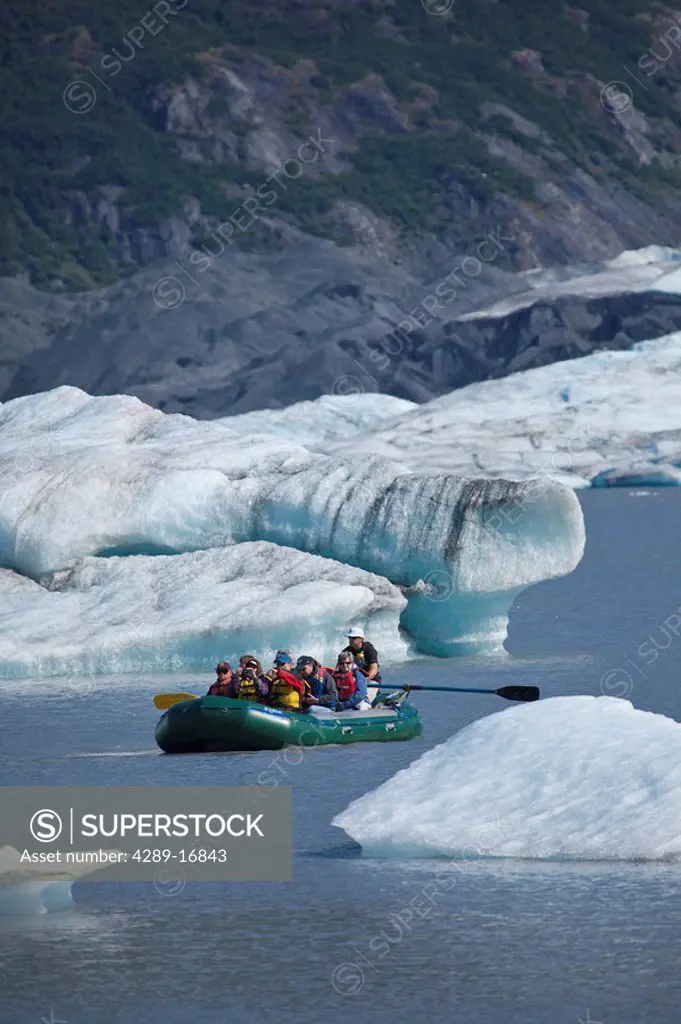 Rafters float among large icebergs calved from the Spencer Glacier in Southcentral Alaska during Summer