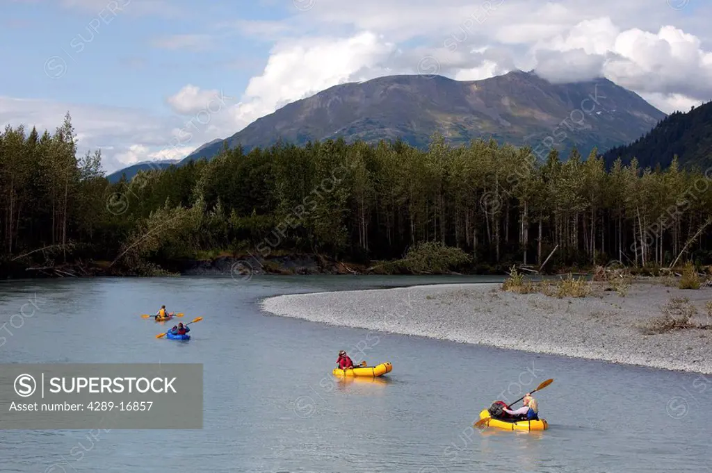People float down Portage Creek in pack rafts during Summer in Southcentral Alaska