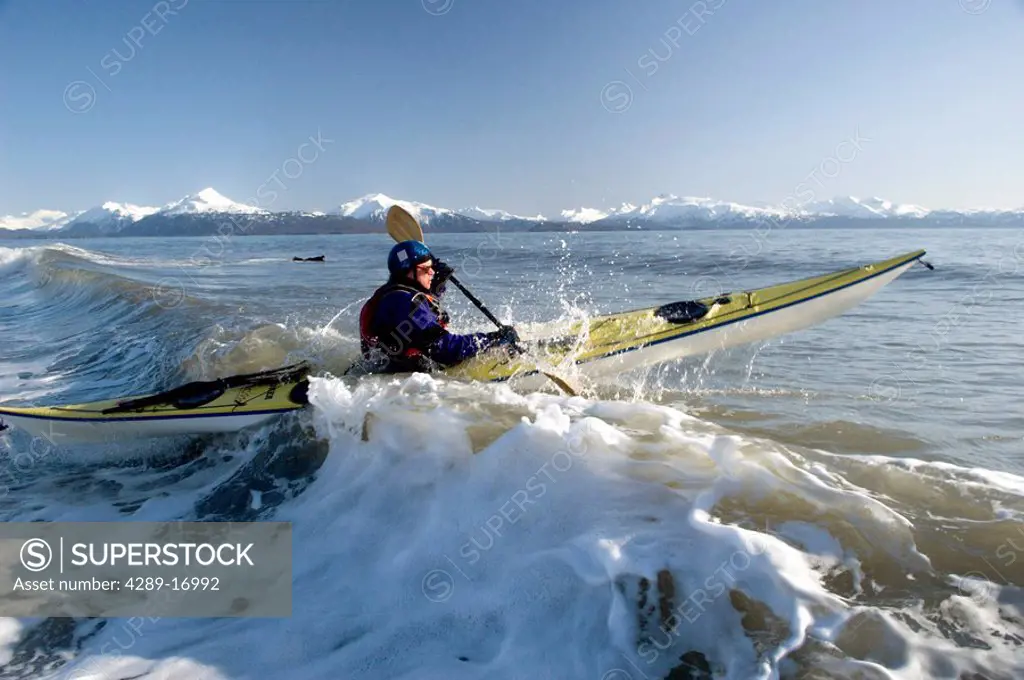 Man Paddles Kayak in Surf Kachemak Bay Homer AK KP Spring