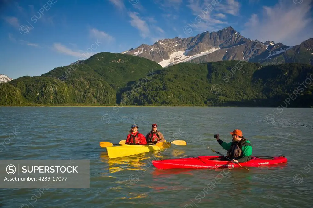 Kayakers on Big River Lakes with Chigmit Mountains in the background in the Redoubt Bay State Critical Habitat Area during Summer in Southcentral Alas...