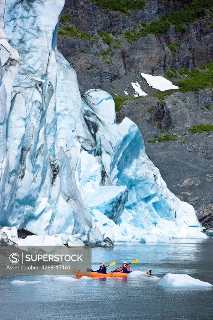 Couple kayaking in Shoup Bay with Shoup Glacier in the background, Prince William Sound, Southcentral Alaska