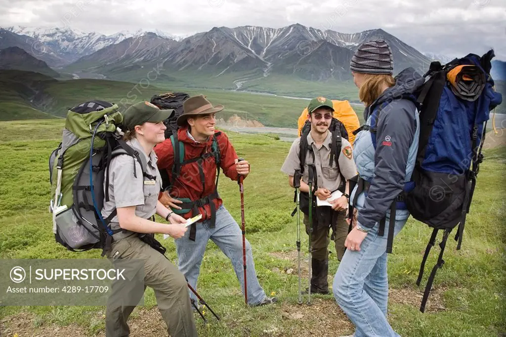 National Park Rangers talk to a couple of backpackers in Denali National Park Alaska