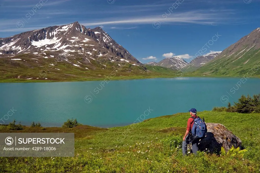 Mature male hiker viewing Lost Lake and Mount Ascension, Kenai Peninsula, Southcentral Alaska, Summer