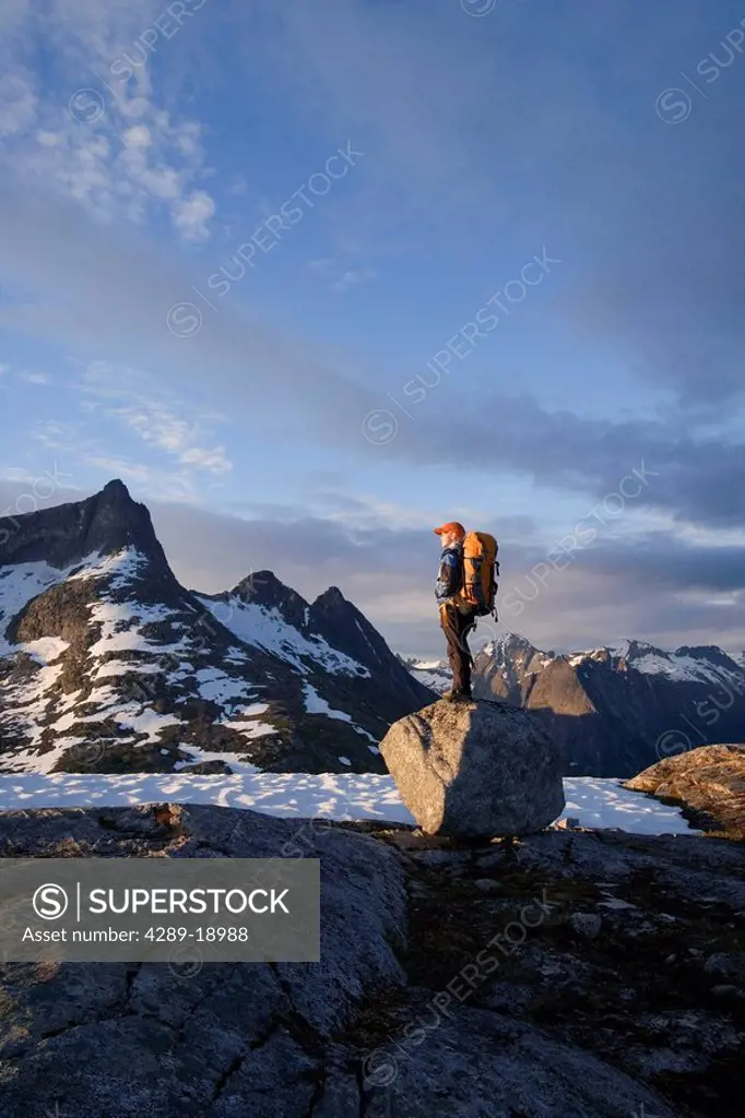 Female Hiker standing on rock overlooking Lynn Canal & Berner´s Bay near Juneau Alaska