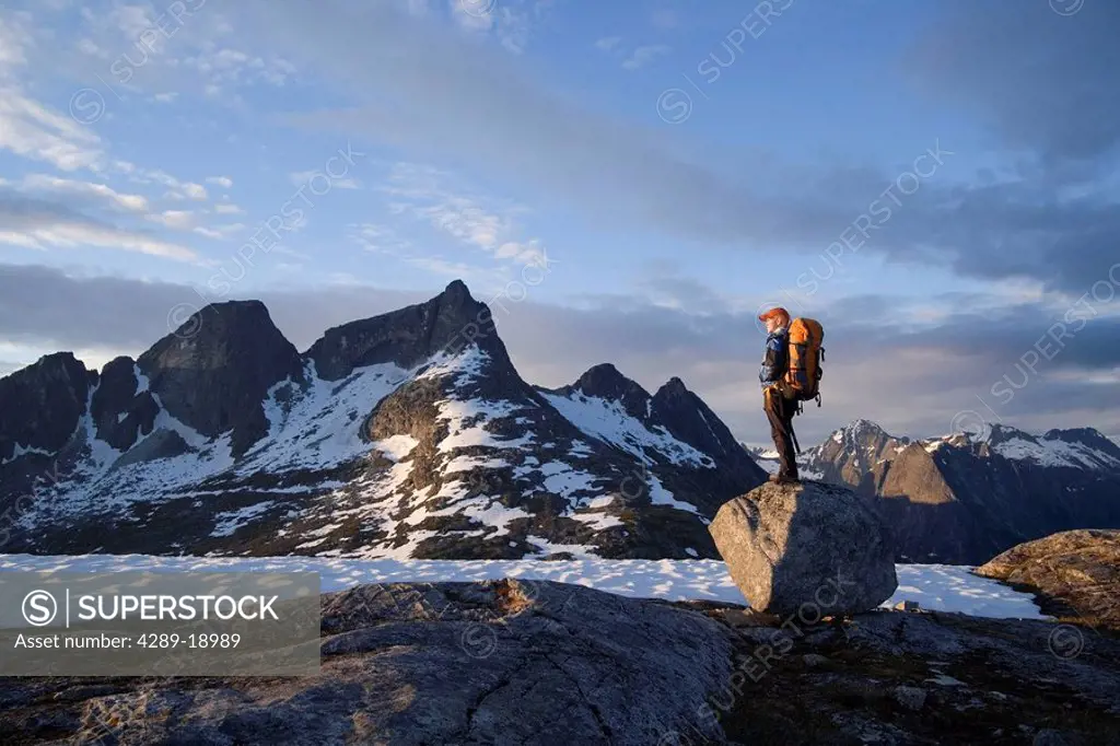 Female Hiker standing on rock overlooking Lynn Canal & Berner´s Bay near Juneau Alaska