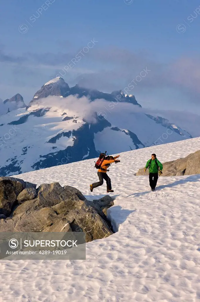 Hikers climb in the afternoon sun on a ridge above the Juneau Ice Field, Juneau, Alaska, Tongass National Forest