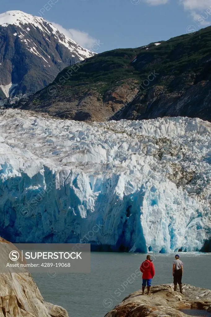 Hikers Stand On Rock And Watch S.Sawyer Glacier AK SE Tracy Arm Fords Terror Wilderness Area