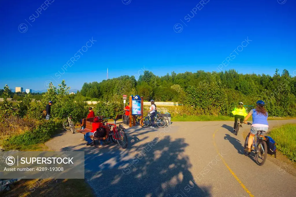 Bicyclists riding on the Tony Knowles Coastal Trail, Anchorage, Southcentral Alaska, Summer