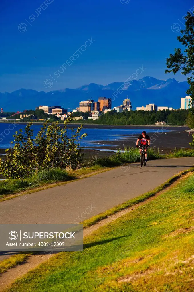 Bicyclist riding on the Tony Knowles Coastal Trail, Anchorage, Southcentral Alaska, Summer