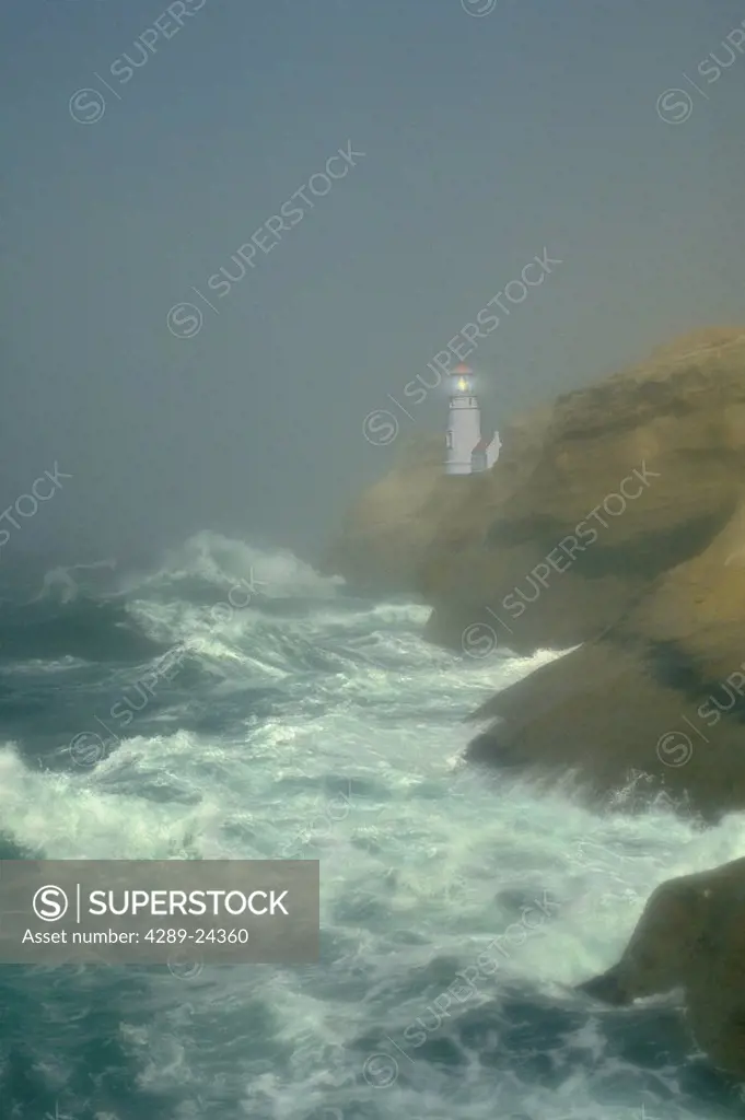 Lighthouse in fog on rock above waves Digital Image summer scenic