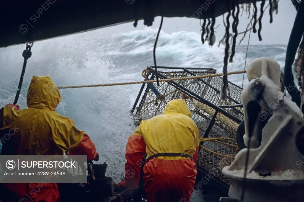 Fisherman Working on Deck in 50 Knot Winds Bering Sea AK /nOpilio Crab Season F/V Erla N