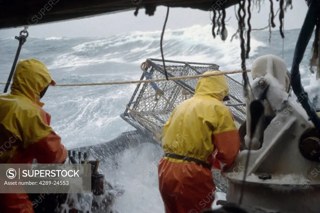 Fisherman Working on Deck in 50 Knot Winds Bering Sea AK /nOpilio Crab Season F/V Erla N