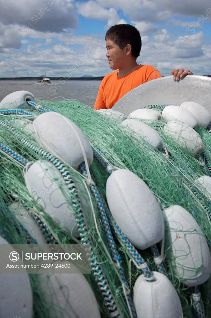 Young boy helping Bristol Bay set net commercial fishermen near Dillingham, Alaska