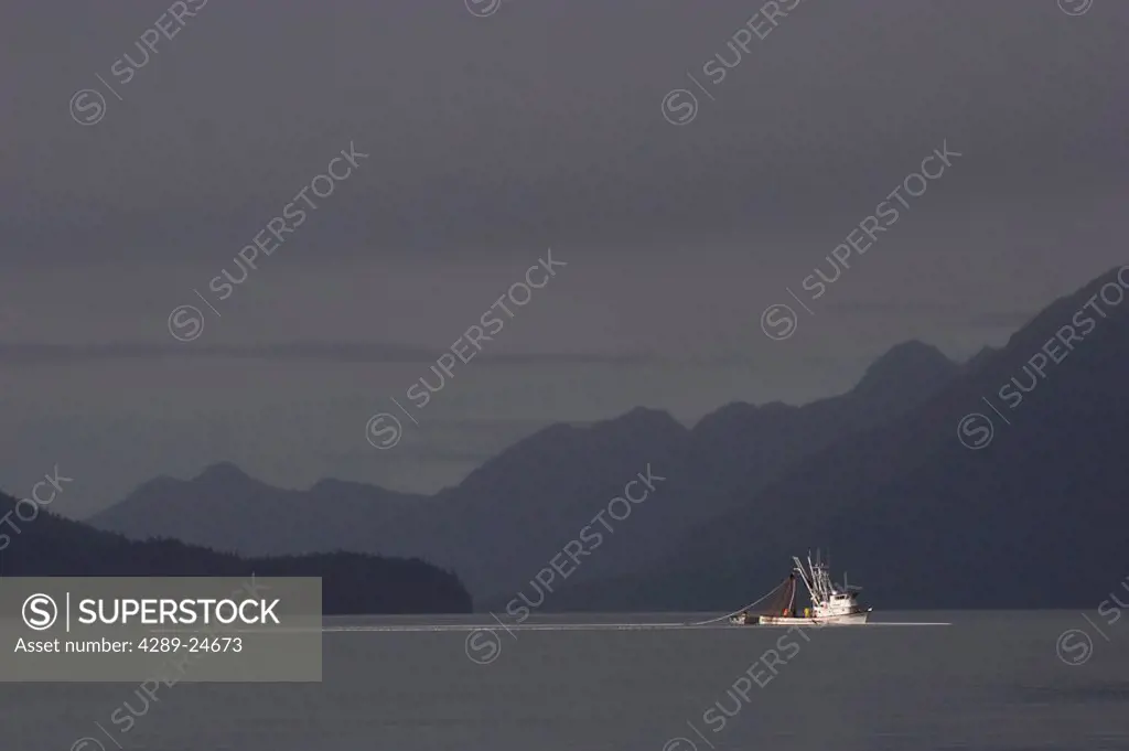 Commercial salmon seiner with net out against stormy sky Port Valdez Prince William Sound Alaska Autumn