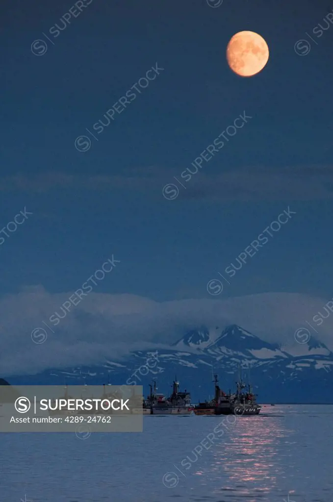 The moon rises over gillnetters rafted together on anchor in Dago Creek in the Ugashik fishing district near Pilot Point, Bristol Bay, Alaska/n