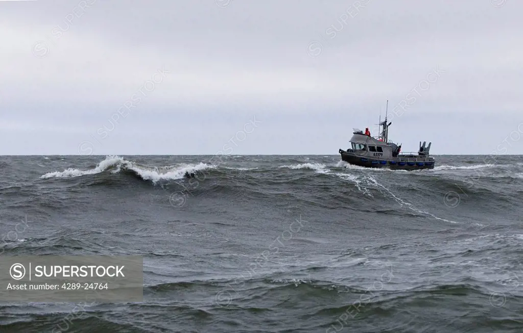 A gillnetter drives through rough seas in the Ugashik fishing district, Bristol Bay, Alaska/n