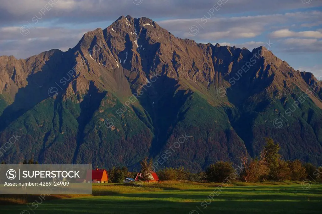 Farm house & barn w/US Flag below Pioneer Peak Chugach Mountains Mat_Su Valley Southcentral Alaska Summer